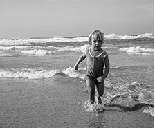 Girl running in surf.