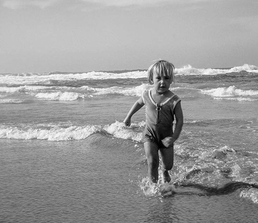 Girl running in surf.